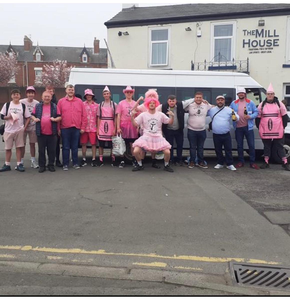 Hartlepool supporters in fancy dress travelling to the last away game of the season by minibus